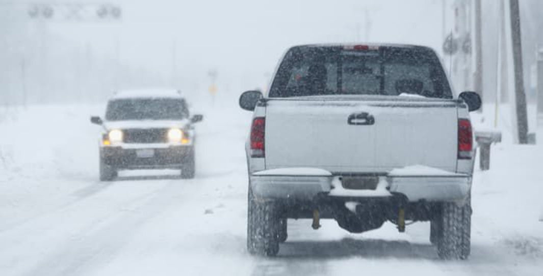 Trucks driving on a salted winter road in New England